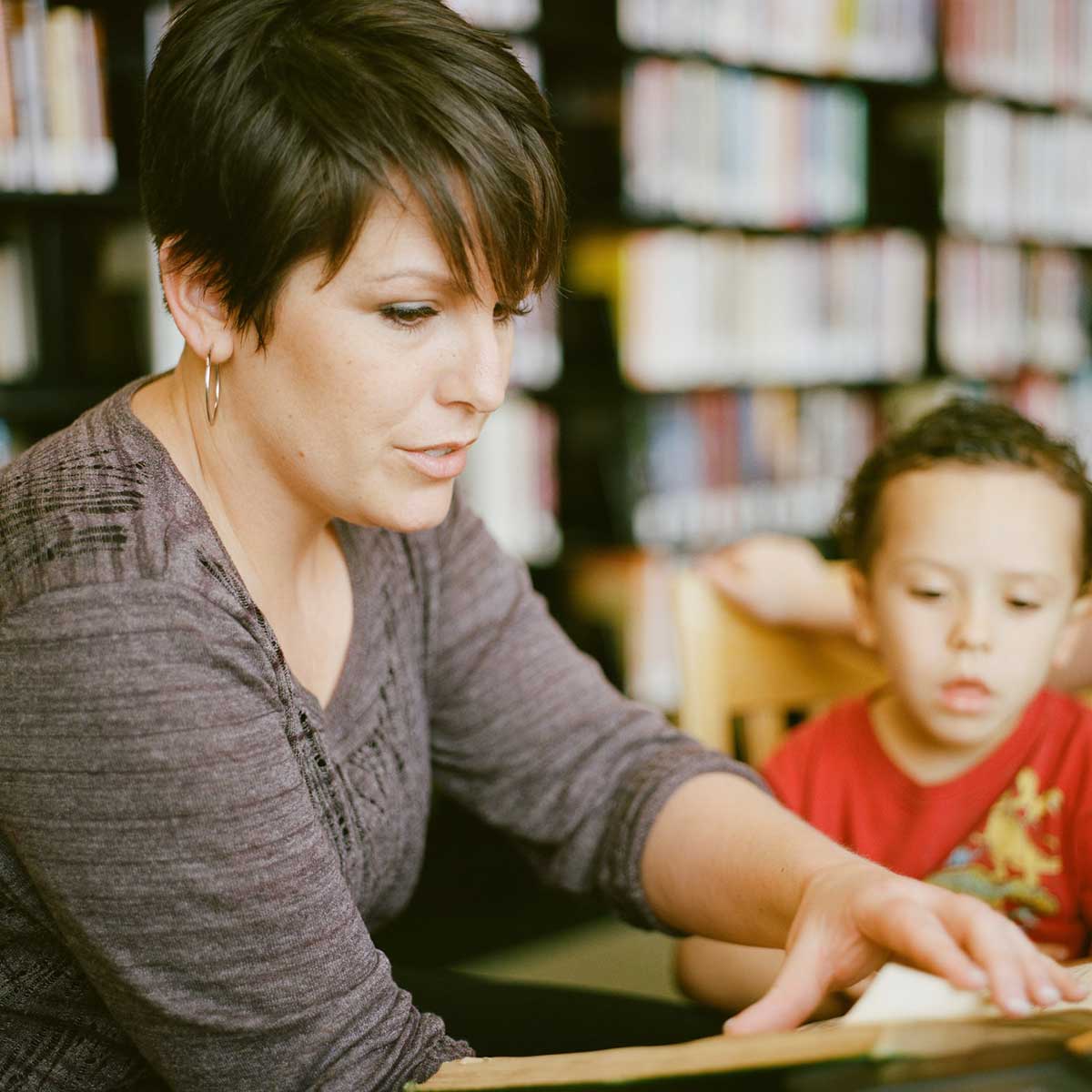 Woman tutoring young boy